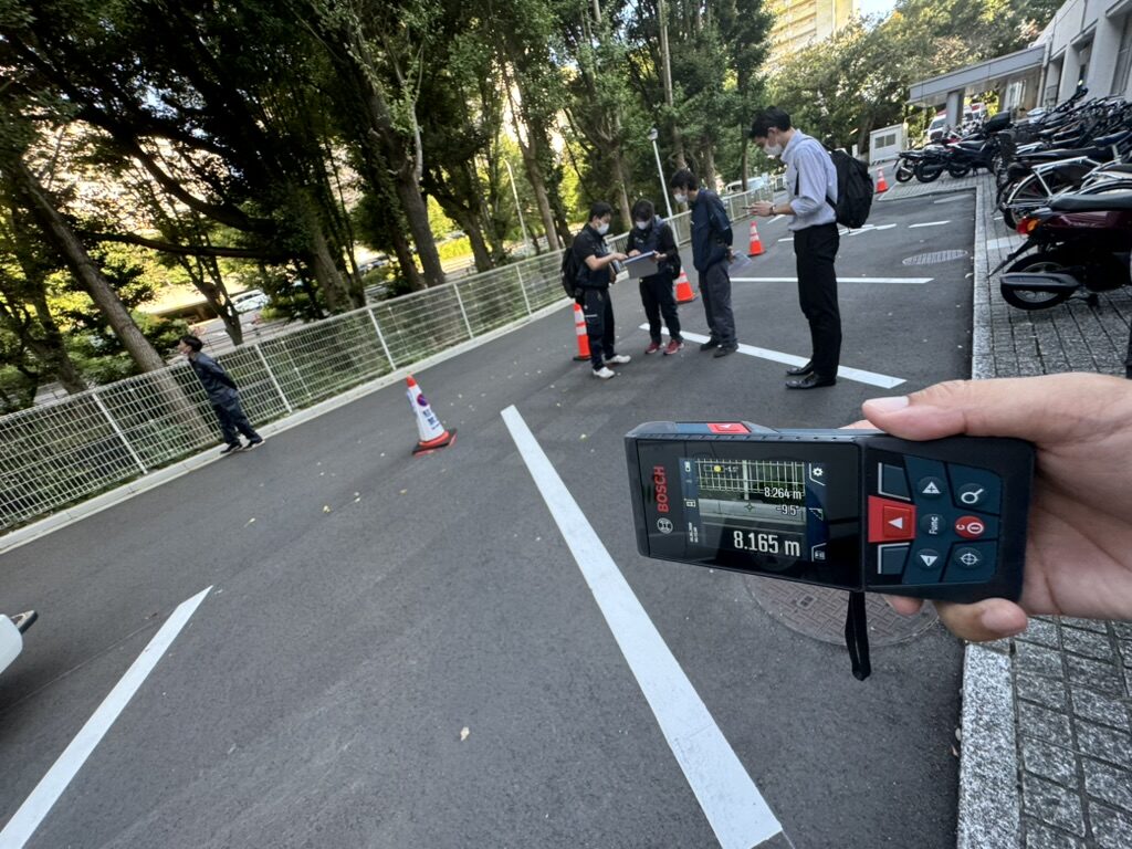 レーザー距離計で現場の距離を実測しているところ